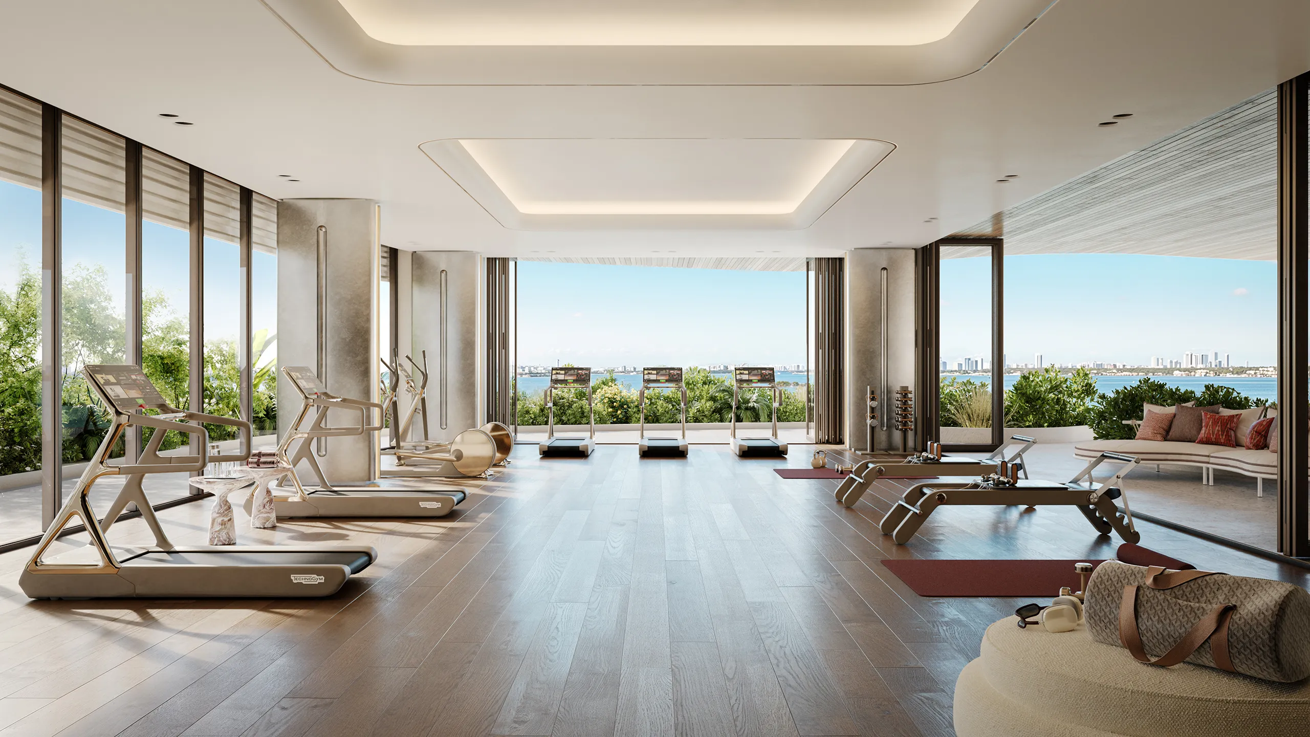 Modern gym with treadmills, exercise machines, and large windows overlooking a waterfront cityscape.